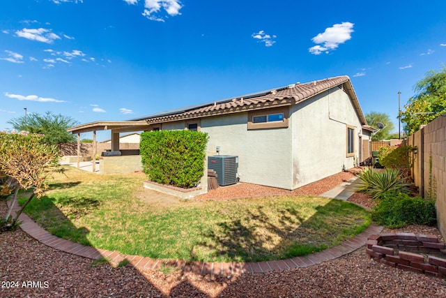 view of home's exterior featuring a lawn, a patio area, and central AC