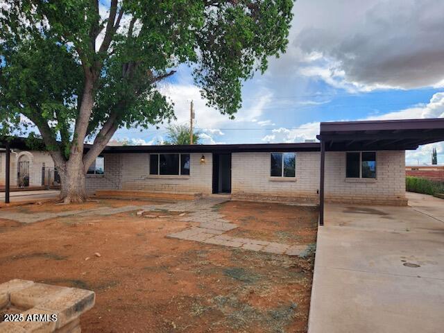 ranch-style house featuring a carport