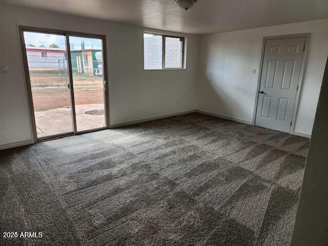 carpeted spare room with plenty of natural light