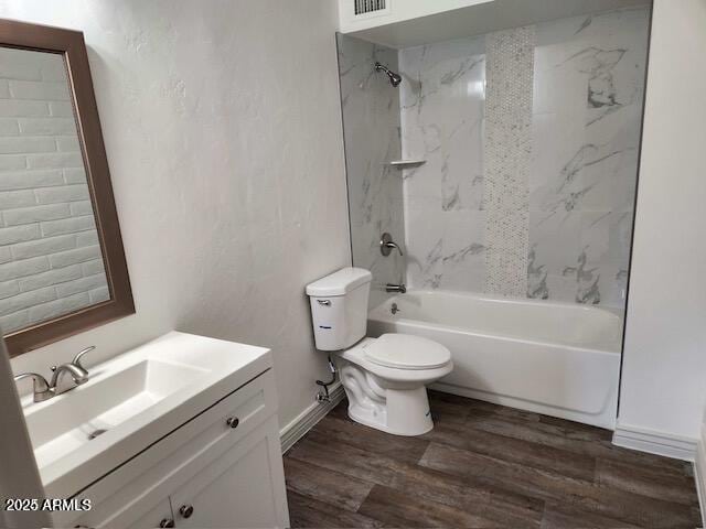 full bathroom featuring vanity, hardwood / wood-style flooring, toilet, and tiled shower / bath