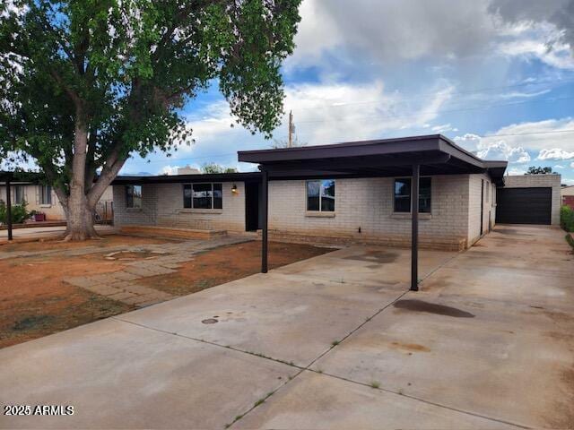 view of front of house with a garage and a carport