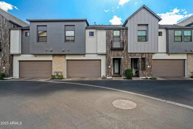 view of property featuring a garage and board and batten siding