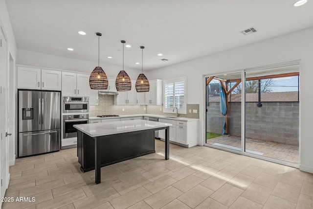 kitchen featuring light countertops, white cabinets, visible vents, and appliances with stainless steel finishes