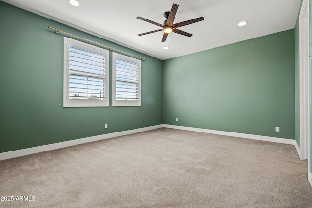 carpeted spare room featuring recessed lighting, baseboards, and a ceiling fan