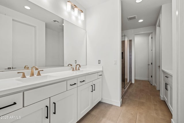 full bathroom featuring recessed lighting, visible vents, and a sink