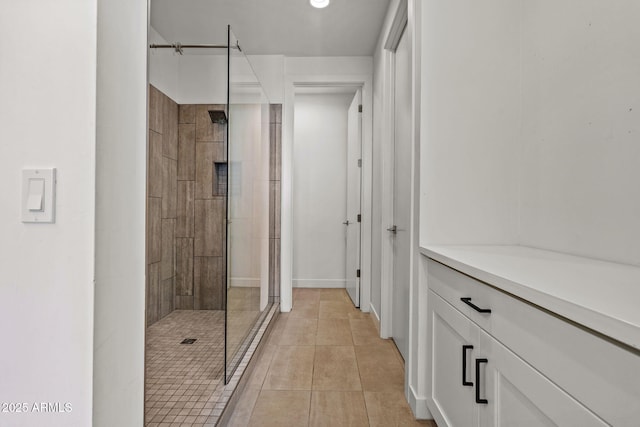 full bath with tile patterned flooring and a tile shower