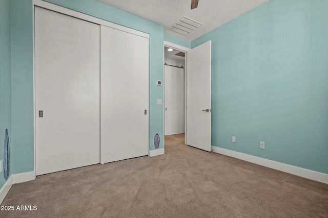 unfurnished bedroom featuring visible vents, ceiling fan, baseboards, carpet floors, and a closet