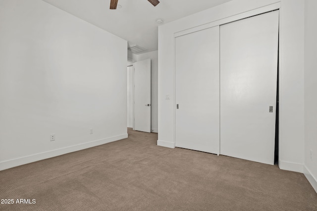 unfurnished bedroom with visible vents, ceiling fan, baseboards, carpet flooring, and a closet