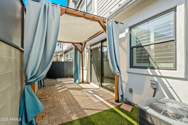 view of patio with central AC unit and fence