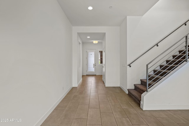 interior space with recessed lighting, baseboards, stairs, and light tile patterned floors