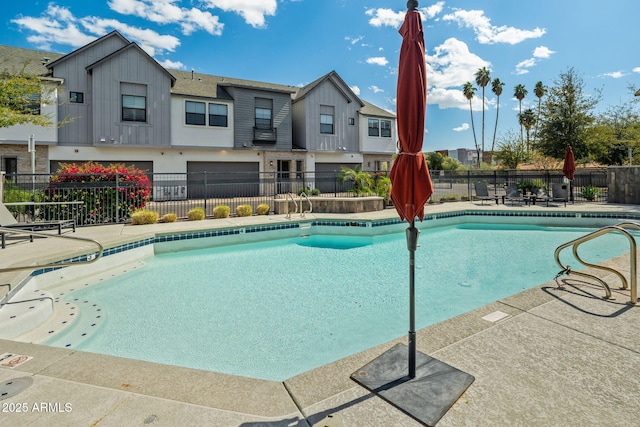 pool featuring a patio and fence