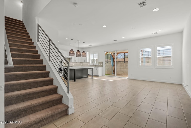 staircase featuring tile patterned floors, visible vents, recessed lighting, and baseboards