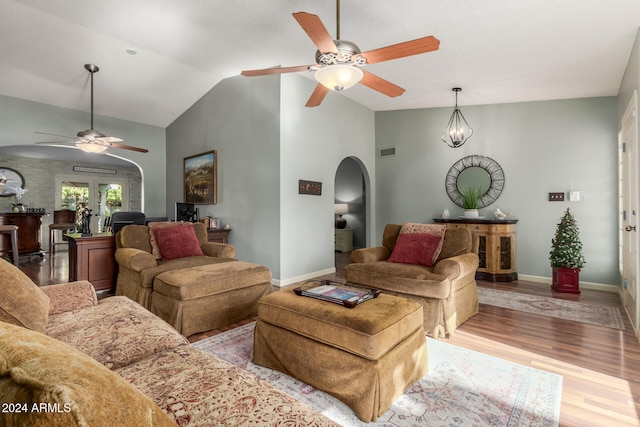 living room with vaulted ceiling, light hardwood / wood-style flooring, and ceiling fan