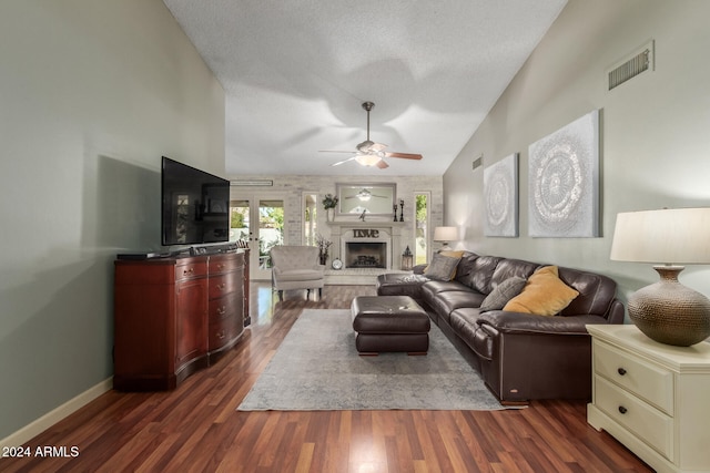 living room with a textured ceiling, high vaulted ceiling, ceiling fan, and dark wood-type flooring