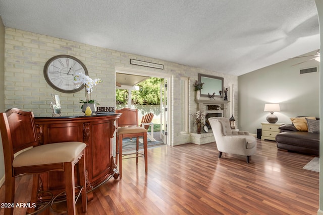 interior space with a textured ceiling and dark hardwood / wood-style floors