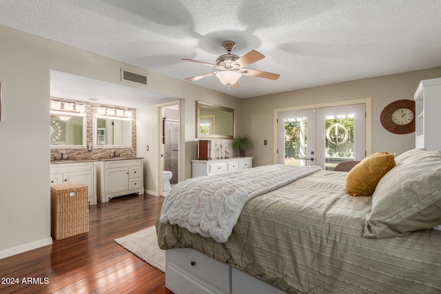 bedroom featuring ensuite bath, a textured ceiling, access to outside, ceiling fan, and dark hardwood / wood-style floors