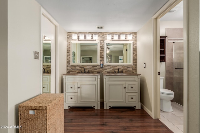 bathroom with toilet, vanity, and hardwood / wood-style flooring