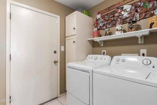 laundry area featuring light tile patterned floors, cabinets, and independent washer and dryer