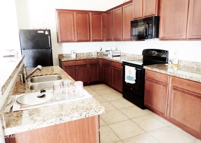30111 N Oak Dr, Florence, AZ 85132 - kitchen with a sink, light stone countertops, black appliances, and light tile patterned floors