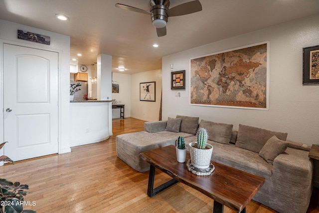 living room featuring light wood-type flooring and ceiling fan