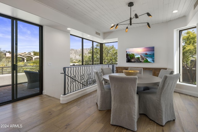 dining space featuring wooden ceiling, plenty of natural light, and hardwood / wood-style floors