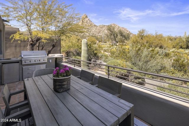 exterior space with a mountain view and a grill