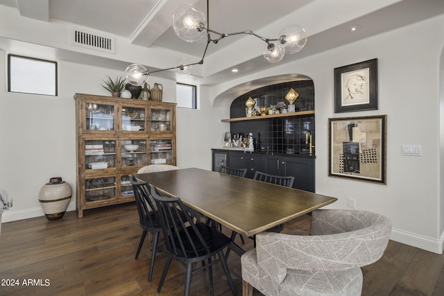 dining room with dark hardwood / wood-style floors and bar