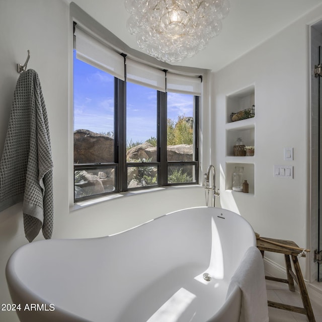 bathroom with a washtub, built in features, tile patterned floors, and a notable chandelier