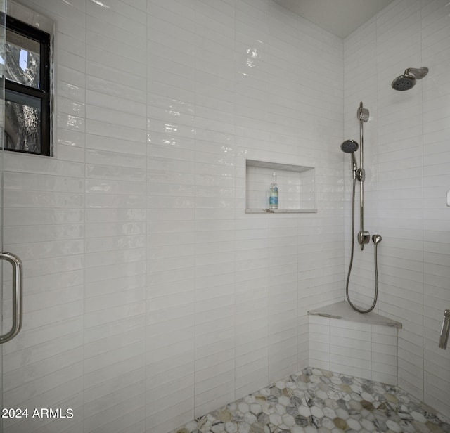 bathroom featuring a shower with door