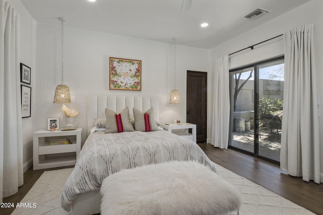 bedroom featuring dark hardwood / wood-style floors and access to exterior