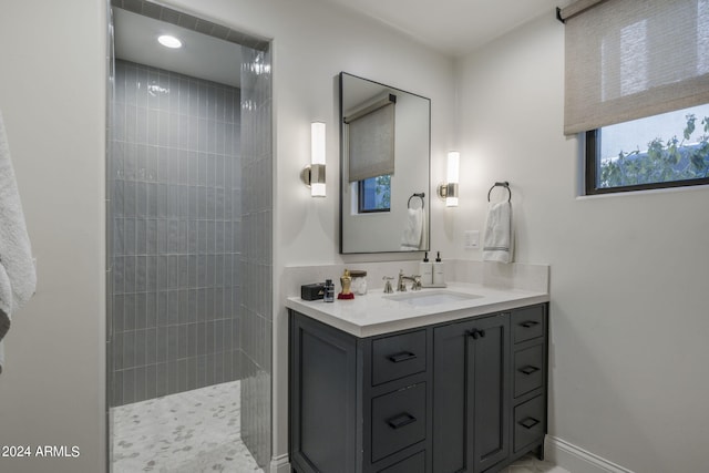 bathroom featuring vanity and tiled shower