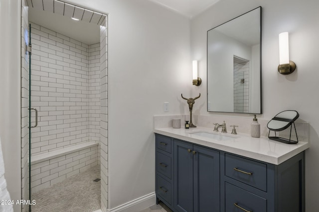 bathroom featuring vanity and tiled shower