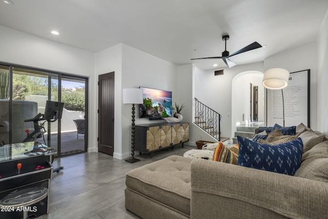 living room with ceiling fan and concrete floors