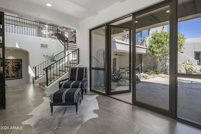 interior space with concrete flooring, a chandelier, and a wealth of natural light