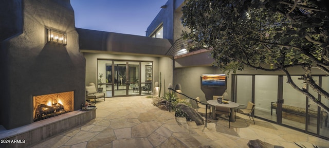 view of patio / terrace featuring exterior fireplace