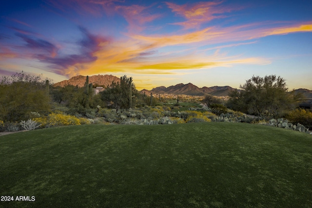 yard at dusk featuring a mountain view