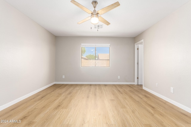 empty room featuring ceiling fan and light hardwood / wood-style flooring