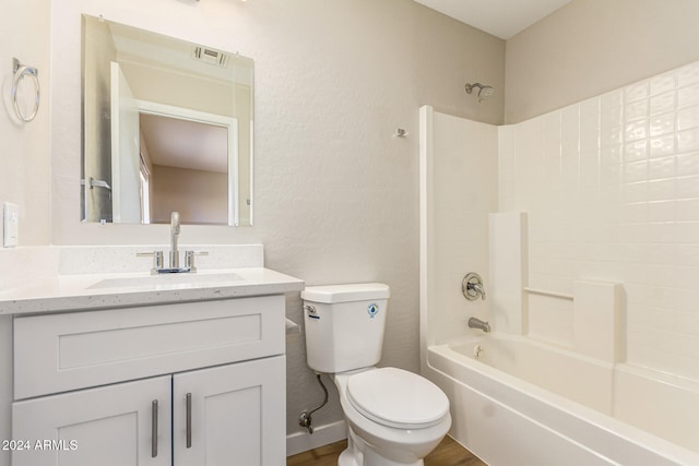 full bathroom with hardwood / wood-style flooring, shower / washtub combination, vanity, and toilet