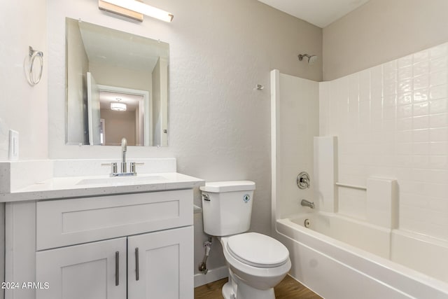 full bathroom with shower / bath combination, hardwood / wood-style flooring, vanity, and toilet