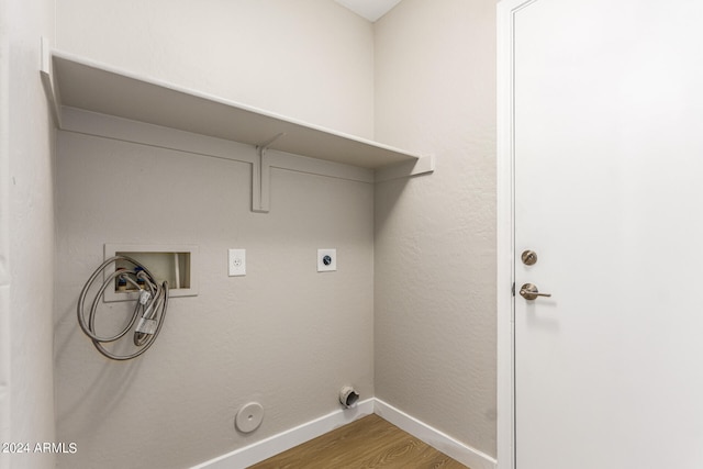 clothes washing area featuring hardwood / wood-style flooring, hookup for a washing machine, and hookup for a gas dryer