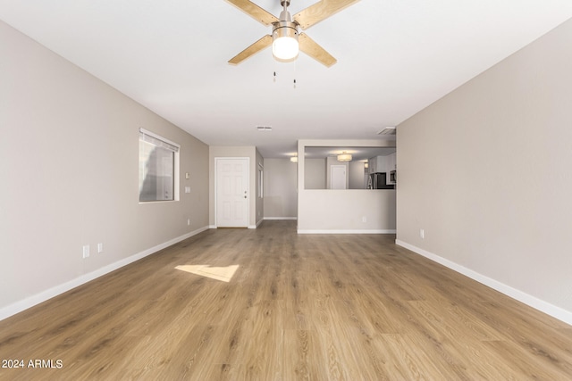 unfurnished living room with light wood-type flooring and ceiling fan