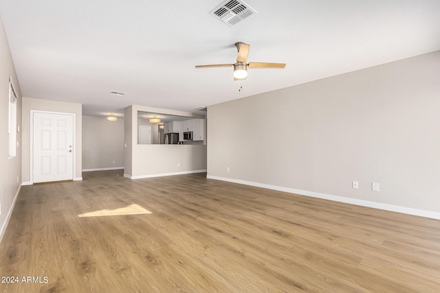 unfurnished living room with ceiling fan and light hardwood / wood-style flooring