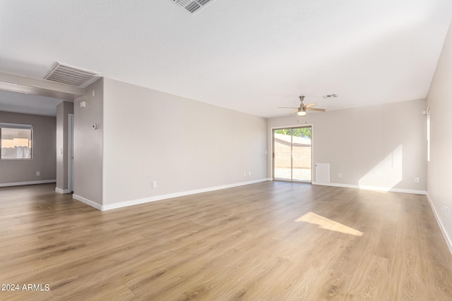 empty room with light wood-type flooring and ceiling fan