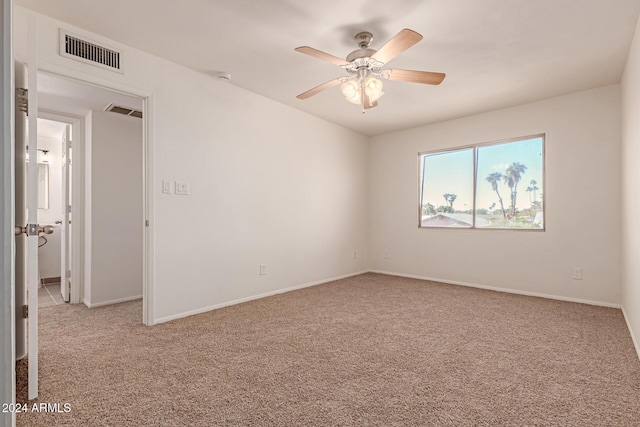 empty room featuring light carpet and ceiling fan