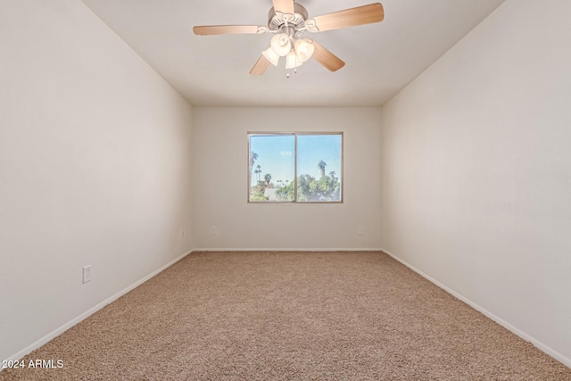 spare room with carpet and ceiling fan