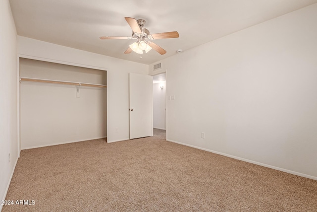 unfurnished bedroom with carpet flooring, ceiling fan, and a closet