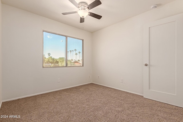 spare room with carpet floors and ceiling fan