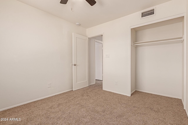 unfurnished bedroom with ceiling fan, carpet floors, and a closet