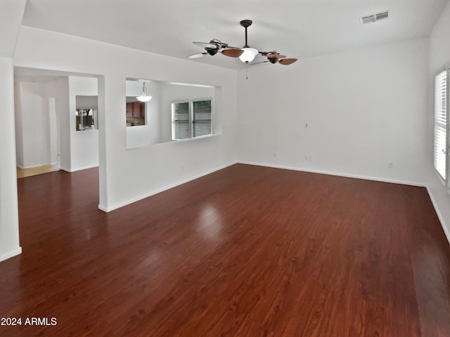 spare room featuring ceiling fan and dark hardwood / wood-style floors