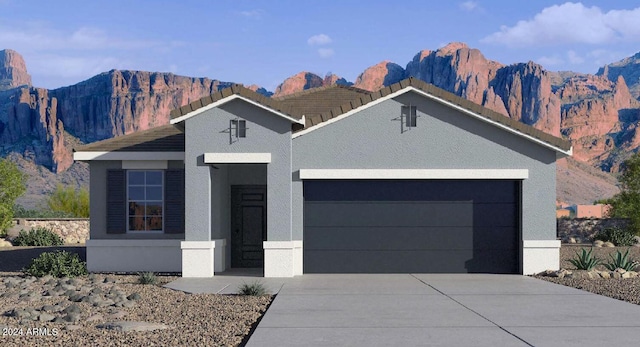 view of front of home with a mountain view and a garage